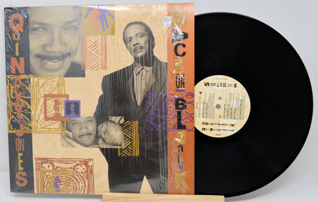 Vinyl record with a colorful cover featuring a collage of faces on a white background