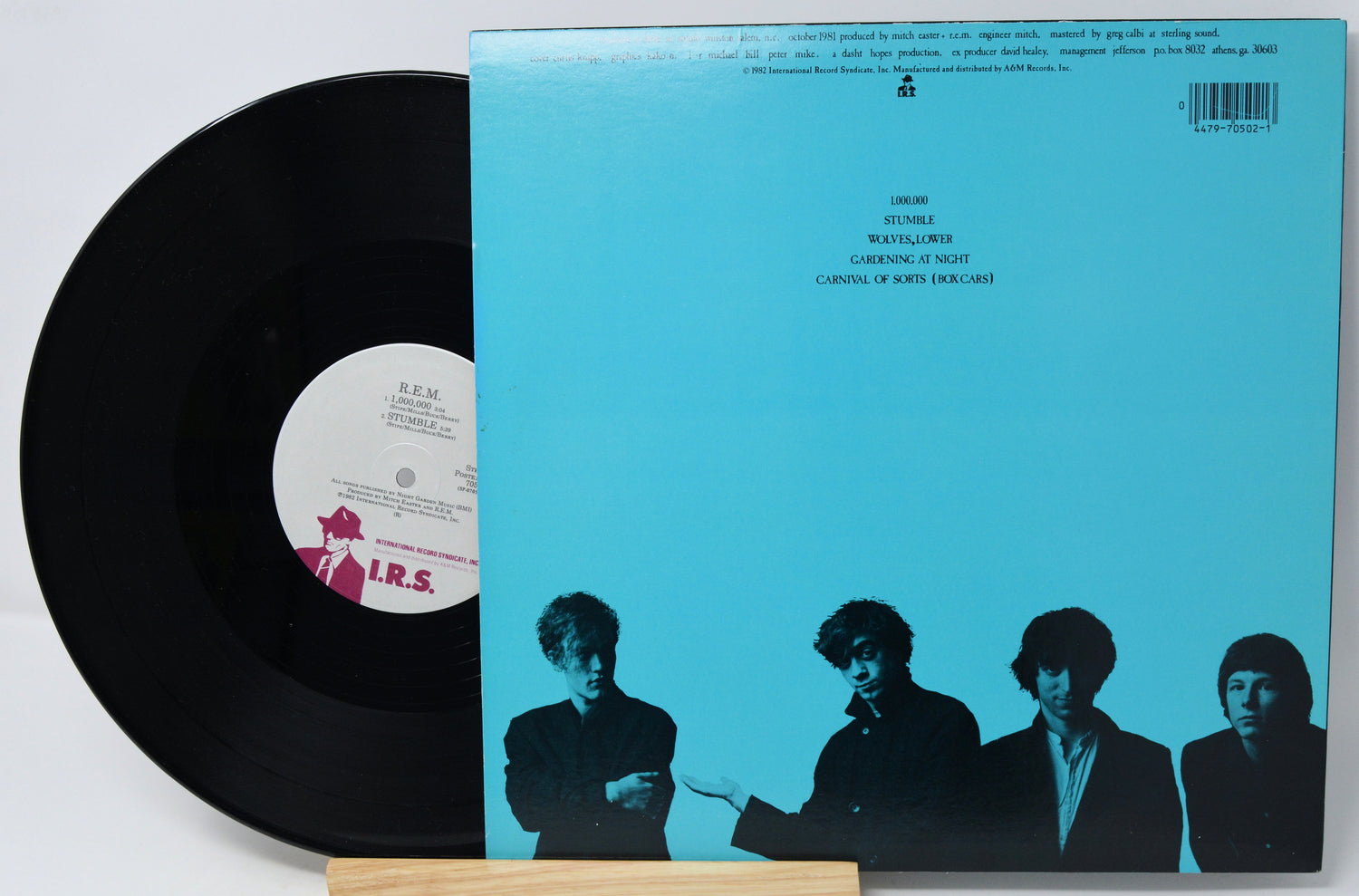 Vinyl record with a blue cover featuring black silhouette images of four people.