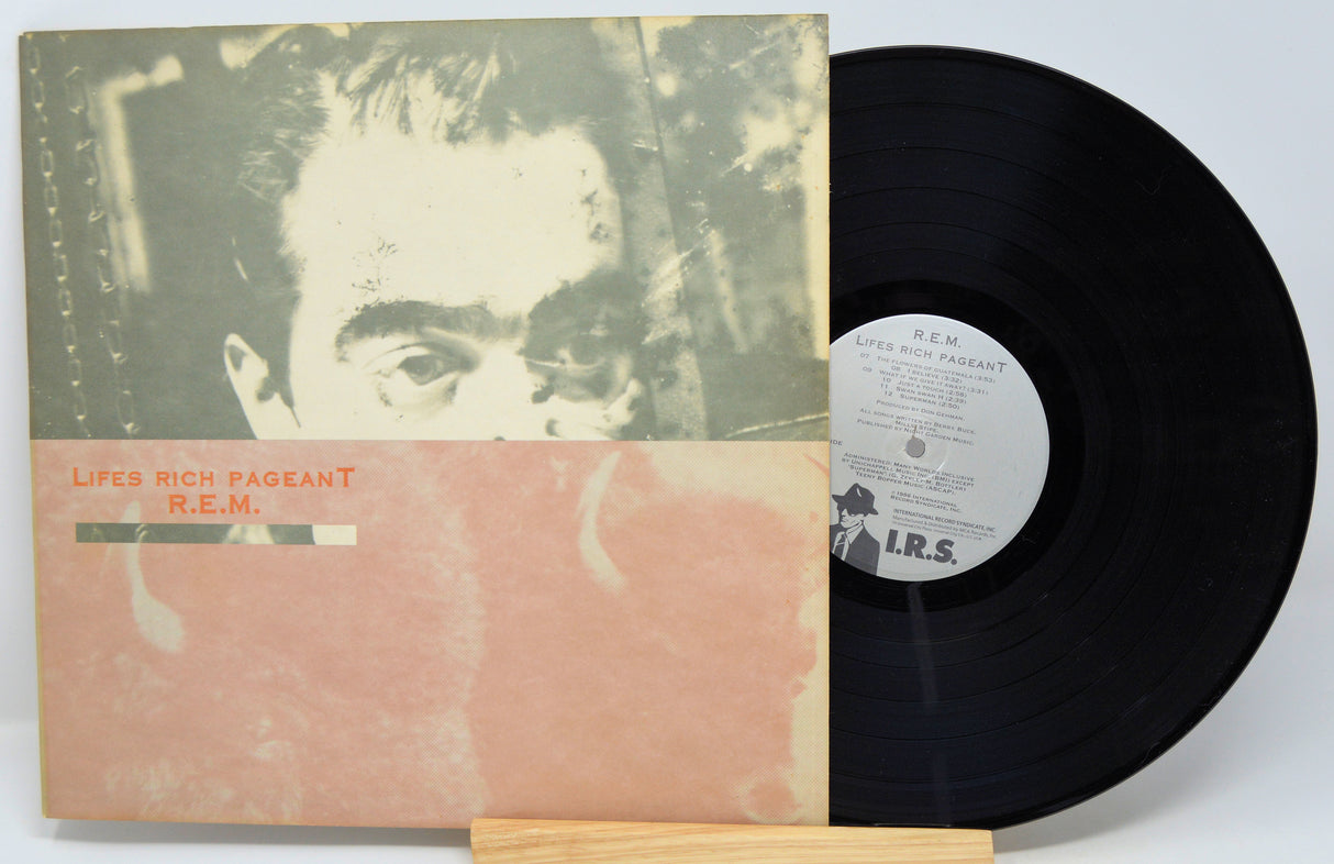 Used vinyl record of R.E.M. - Life's Rich Pageant with the album cover and a vinyl record displayed in front of it.