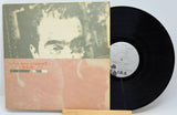 Used vinyl record of R.E.M. - Life's Rich Pageant with the album cover and a vinyl record displayed in front of it.