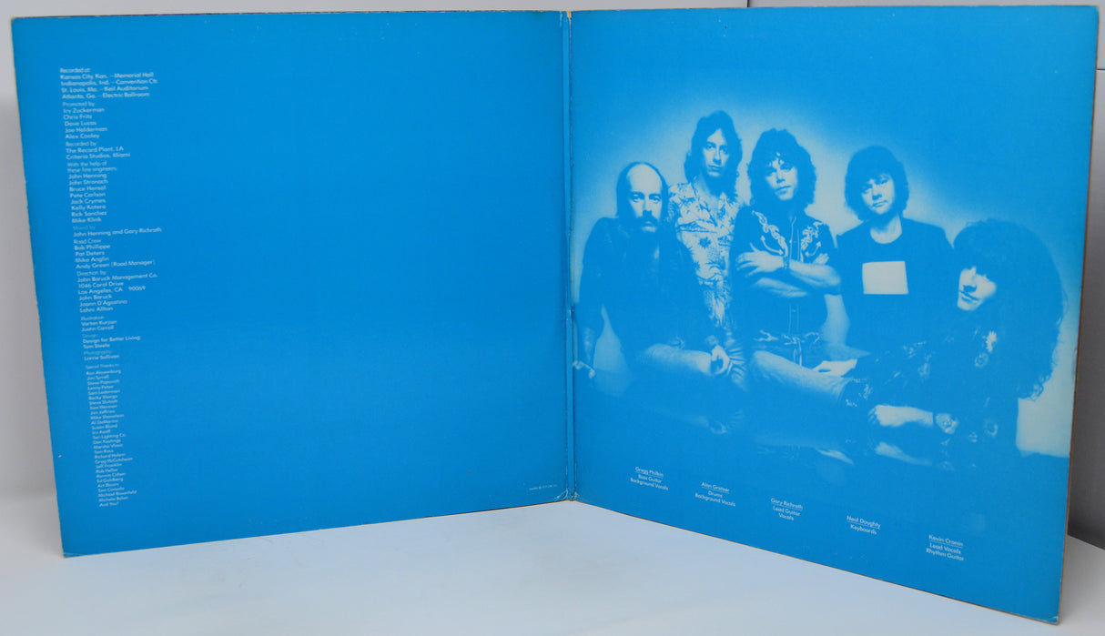Blue album cover with a band photo and text on a white background