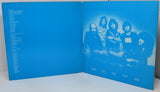 Blue album cover with a band photo and text on a white background