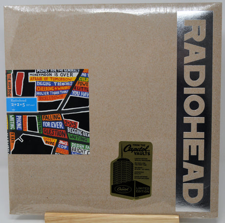 Radiohead 'From the Crystal Vaults' limited edition CD jewel case, sealed in plastic shrink wrap. The cover is a textured light brown/kraft paper style with a black vertical band on the right featuring the band name 'RADIOHEAD' in beige.