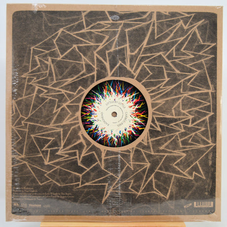 Vinyl record LP in shrink wrap with abstract geometric artwork in tan and black, featuring a colorful circular center label. The record label is visible in the center.
