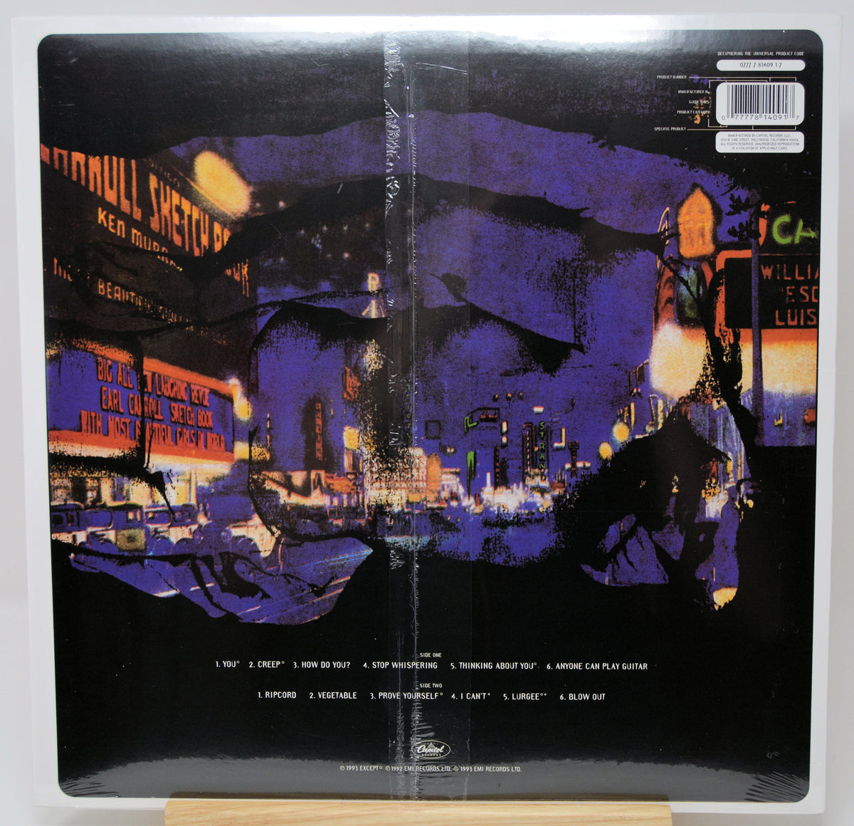 The back cover of a vinyl record sleeve for Ken Russell's 'Bodmull Sketches' LP, featuring a stylized purple and black cityscape illustration with tracklist text at the bottom.