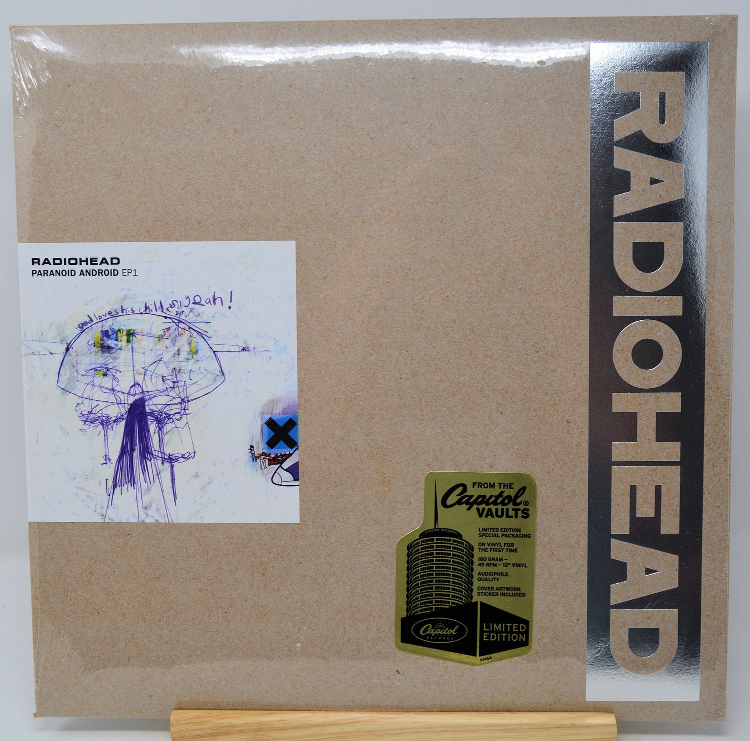 Radiohead 'Paranoia Argentinia' 12-inch vinyl record cover, limited edition, featuring a textured kraft-paper background, a vertical black band with gold 'RADIOHEAD' text, and a white album art insert on the left.