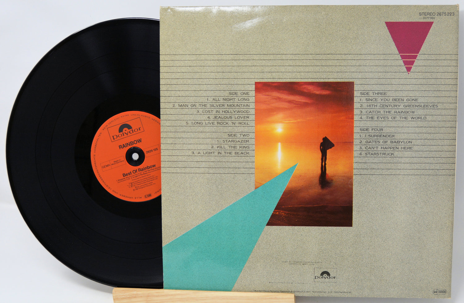 Vinyl record with a colorful album cover featuring a sunset and geometric shapes.