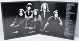 Album cover with black and white portrait of a band on the left and text on the right.