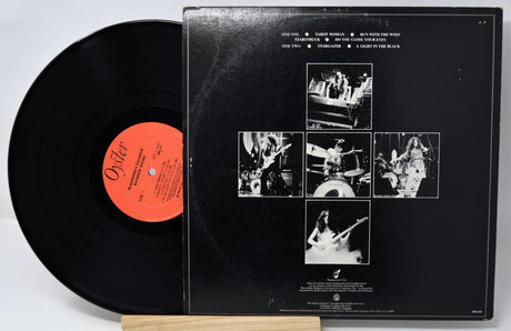 Vinyl record with a black cover featuring black and white images and a red label.