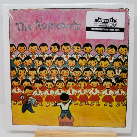Vinyl record cover with illustrated design of children in uniform and two figures playing accordions, featuring 'The Raincoats' and Newbury Comics logos.