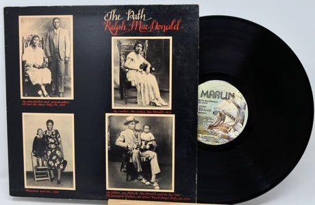 Vinyl record with black cover featuring black and white photos and 'Marlin' label.