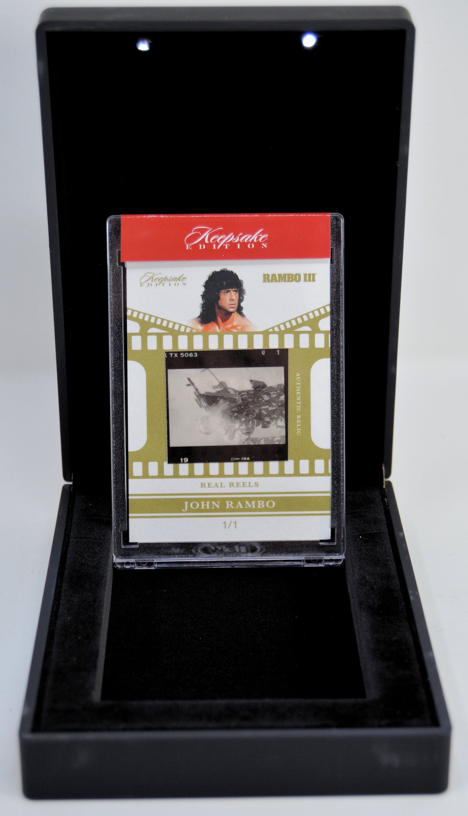 Rambo III collectible reel card with film strip displayed in a deluxe black case