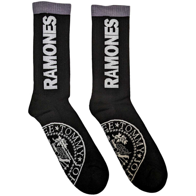 A pair of black ankle socks with the word 'RAMONES' printed in white on the side, featuring a 'Presidential Seal' design motif.