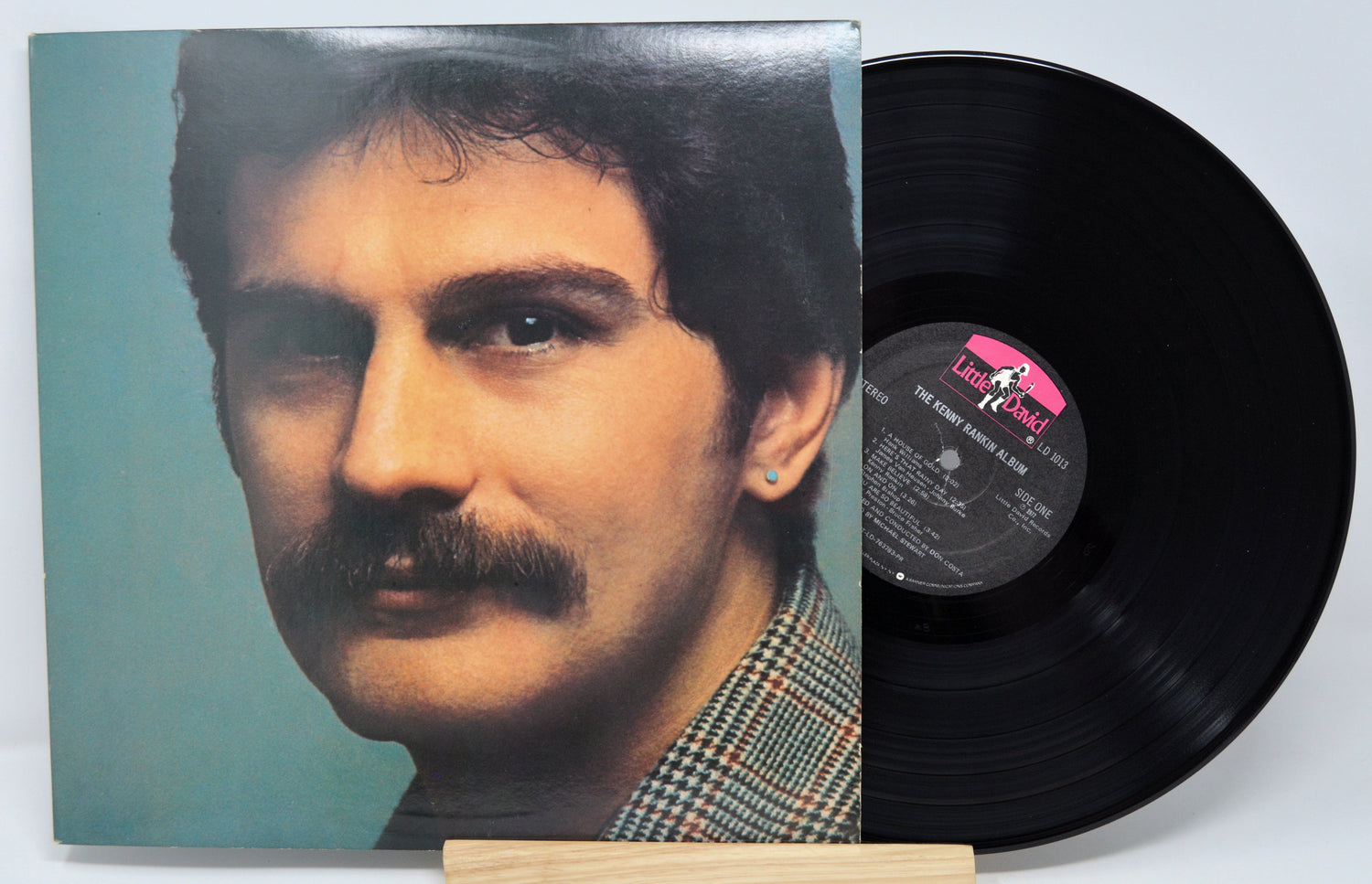 Vinyl record with a portrait on the cover and a white background
