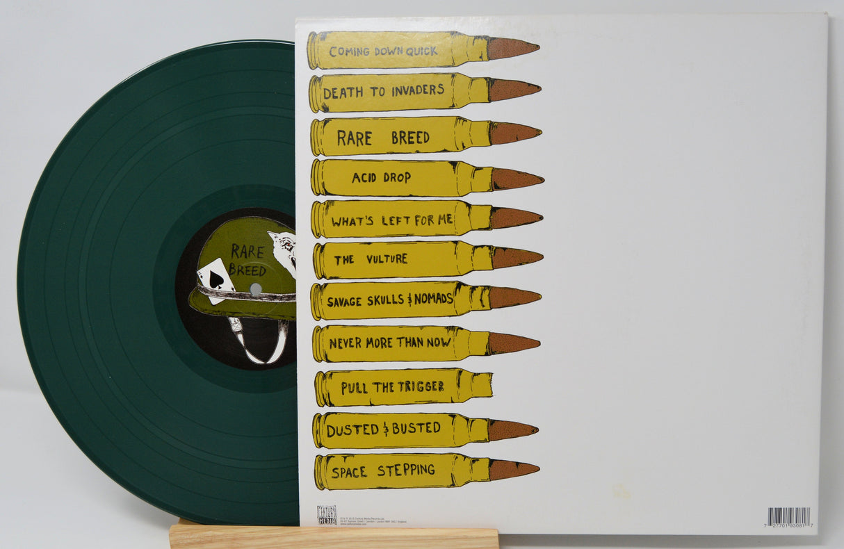 Green vinyl record with Rare Breed label, and album track listing printed on bullets on the back cover