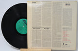Vinyl record with a green label and its cover on a white background