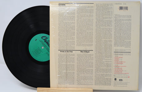 Vinyl record with a green label and its cover on a white background