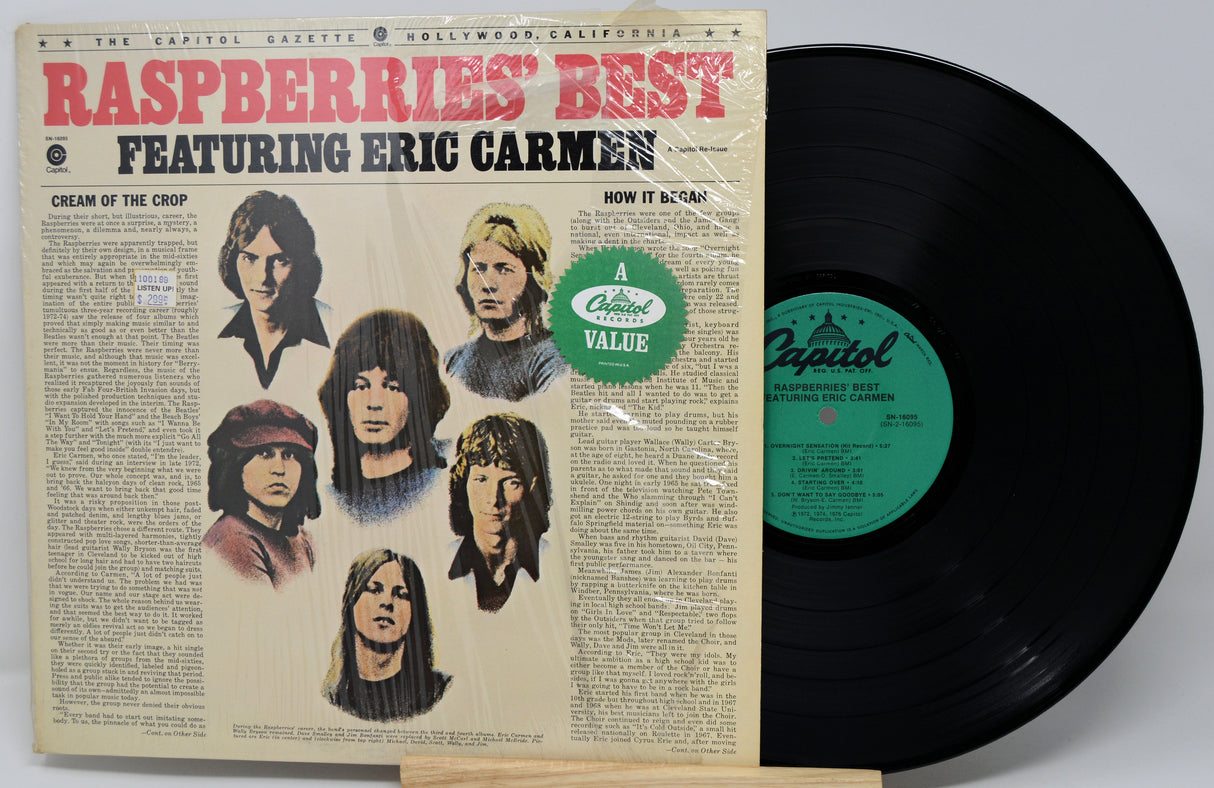 Vinyl record with cover featuring 'Raspberries' Best' and 'Eric Carmen' on a gray background