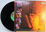 Ratt, Out of The Cellar Vinyl record with a colorful back cover featuring images of a person and text.