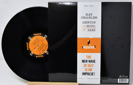 Ray Charles 'Genius + Soul + Jazz' LP record shown with the black vinyl disc, black sleeve, and white/orange Impulse label on a light background.