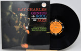 Ray Charles 'Genius + Soul = Jazz' vinyl record album with the black LP disc partially pulled from the sleeve, photographed on a light gray background.