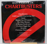 Album cover of 'Chartbusters' by Ray Parker Jr. with a red and black design.