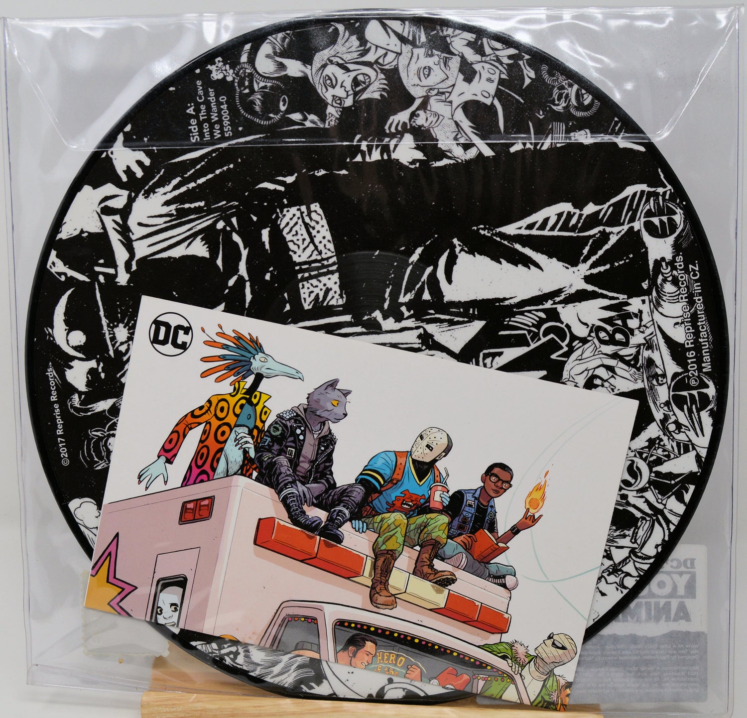 Vinyl record with a black and white cover featuring cartoon characters and a colorful cover with people on a truck.