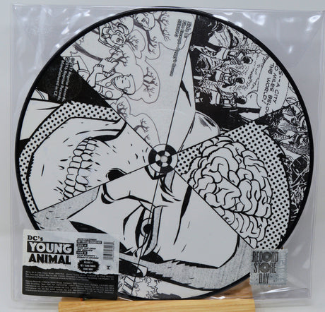 Vinyl record with black and white artwork and 'DC's Young Animal' label on a clear sleeve.