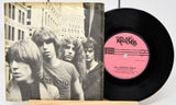 Vinyl record with a pink label featuring a band portrait on the cover