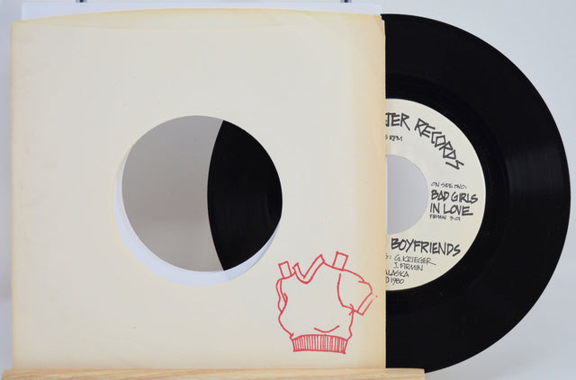 Red Sweater Records 7 inch vinyl single partially in a sleeve with red sweater illustration