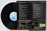Vinyl record with cover displaying tracklist on a light gray background