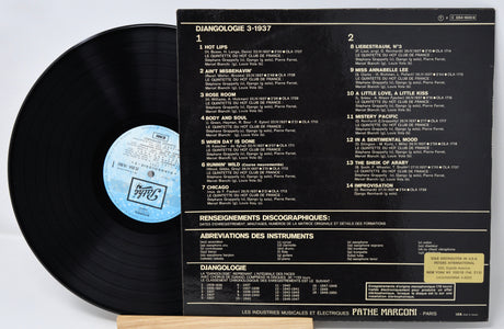 Vinyl record with cover displaying tracklist on a light gray background