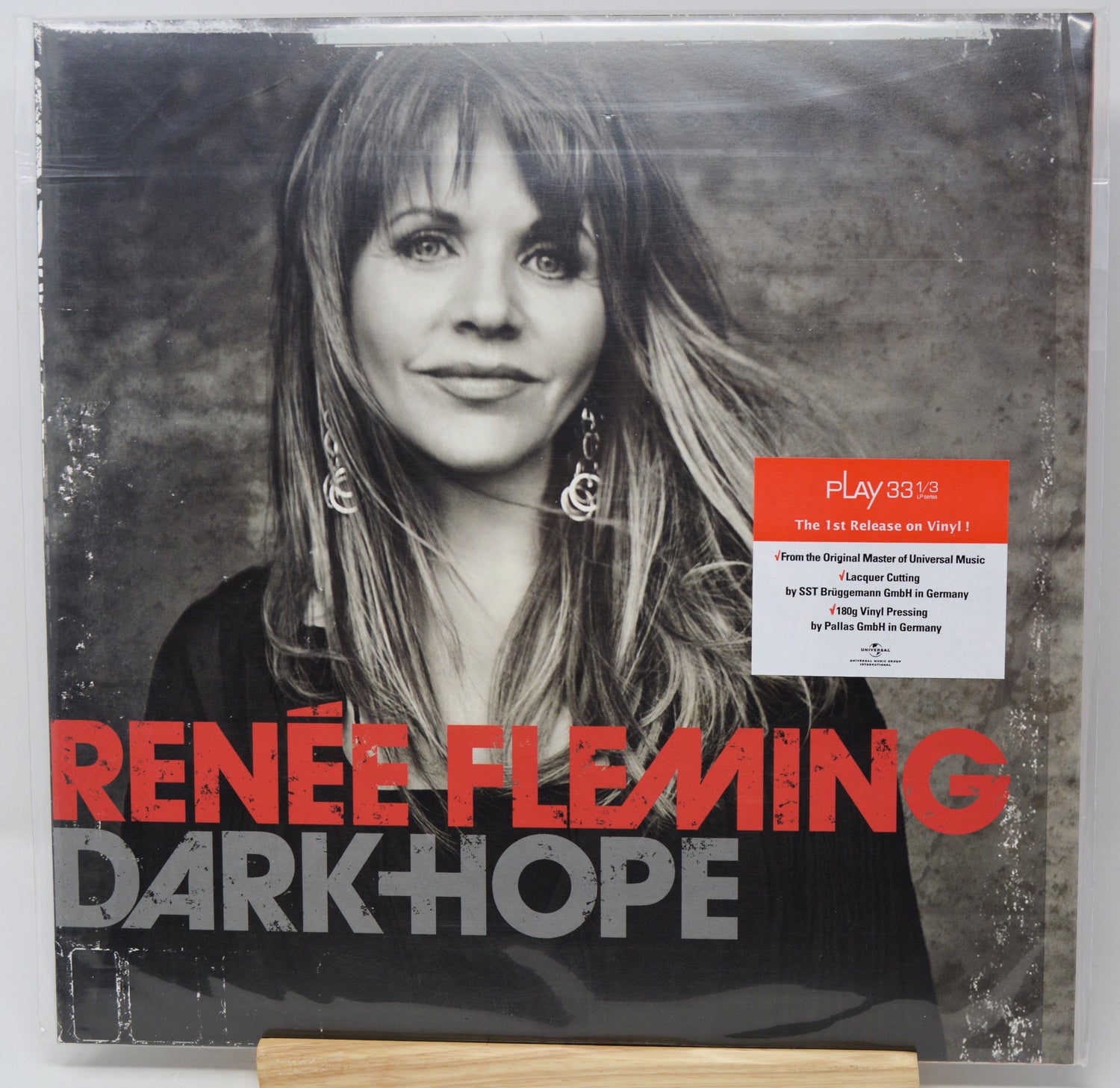 Renée Fleming's 'Dark Hope' vinyl record album cover, sealed in plastic shrink wrap with a small Play3313 sticker on the front. The cover features a black and white portrait of the artist, bold red and gray text, and a white information label.