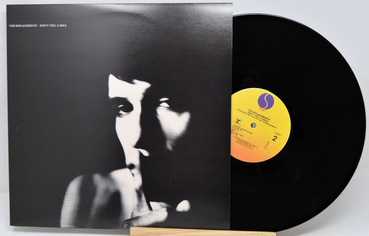 Vinyl record album with the cover partially pulled open, revealing a black LP. The cover features a high-contrast black-and-white portrait and the text 'THE BLACKSHOTS - DON'T TELL A MAN' at the top left.