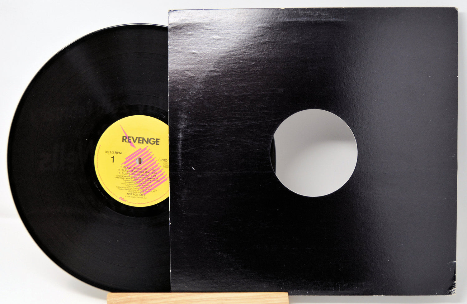 Revenge 'Slave' 12 inch promo vinyl single displayed with black generic sleeve