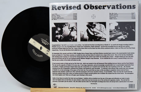 Vinyl record with cover displaying 'Revised Observations' text and album artwork.