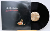 Vinyl record with cover featuring a guitar player and album title 'Manzanita' on a white background