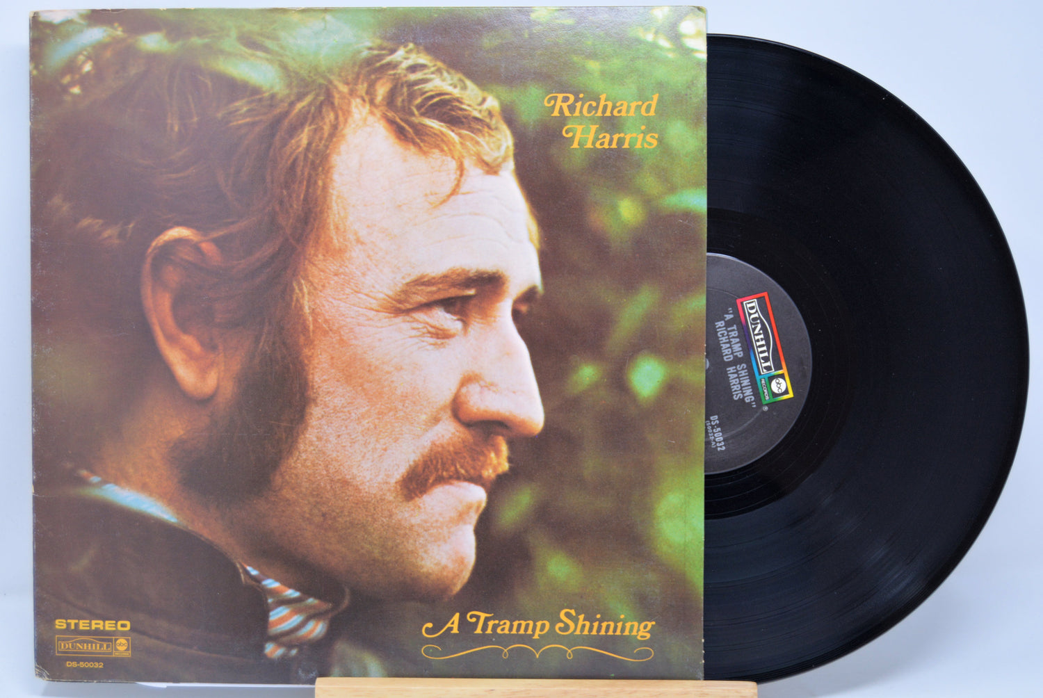 Vinyl record with cover featuring a man's profile and 'Richard Harris, A Tramp Shining' text on a light blue background