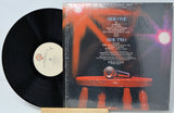 Vinyl record with cover featuring text and a red and black design.