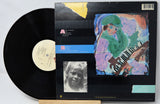 Vinyl record with a colorful cover featuring a person playing a keyboard.