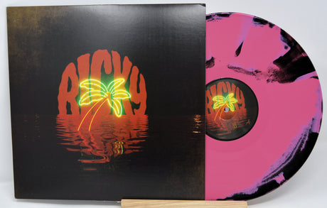 Vinyl record with colorful design on black cover