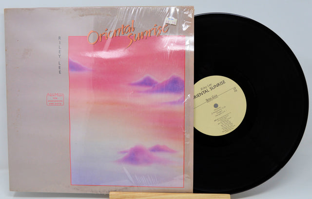 Vinyl record with a colorful cover and black disc on a light gray background