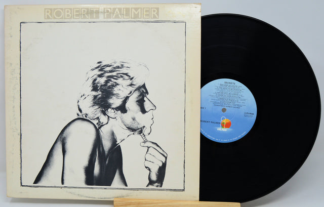Robert Palmer 'The Sound of the World' vinyl record LP, showing the cream-colored illustrated album cover sleeve alongside the black vinyl record on a light gray background.
