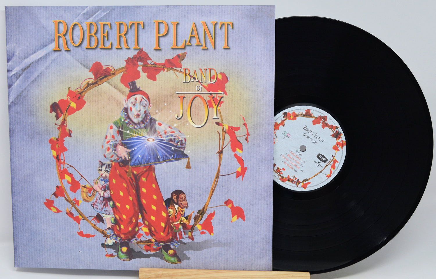 Robert Plant's 'Band on the Run' vinyl record LP, showing the illustrated album cover on the left and the black vinyl record partially pulled out on the right.