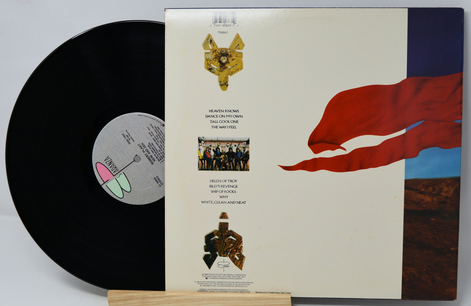Vinyl record with a colorful cover featuring a red flag and text.