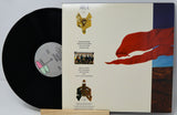 Vinyl record with a colorful cover featuring a red flag and text.