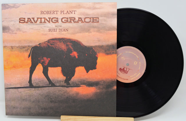 Robert Plant's 'Saving Grace' vinyl record album with the sleeve standing in front of the black record on a small wooden display stand.