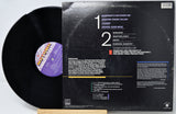 Vinyl record with cover displaying tracklist and album art on a white background