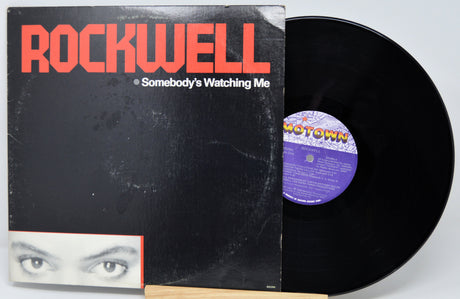 Vinyl record with 'Rockwell' album cover featuring a face and text.