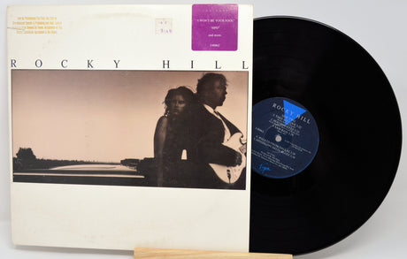 Vinyl record and cover with a silhouette of a couple on a beach